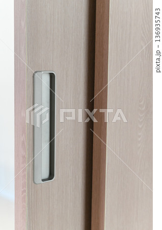 Sliding door wooden surface recessed handle modern style light brown color minimalist design interior vertical lines smooth texture home decor contemporary look Sliding door wooden surface recessed handle modern style light brown color minimalist design interior vertical lines smooth texture home decor contemporary look 136935743