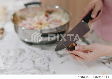 Home cooking with pork and shabushabu style includes preparing fresh ingredients like mushroom on marble kitchen counter for delicious homemade meal experience 136935814