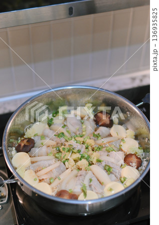 Pork shabushabu home made cooking with tofu mushroom and vegetables in stainless steel pot on stove, delicious and comforting meal for family gatherings 136935825