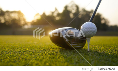 Golf clubs and balls on a green lawn in a beautiful golf course with morning sunshine. 136937028