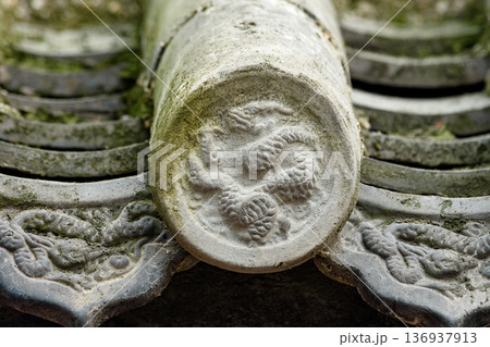 Close-up of dragon relief on traditional roof ridge tile 136937913