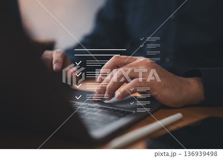 Close-up of person typing on laptop keyboard with checklist overlay for productivity and task management Close-up of person typing on laptop keyboard with checklist overlay for productivity and task management 136939498