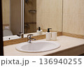 Modern bathroom sink with mirror soap dispensers and clean countertop 136940255