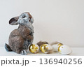 Cute bunny figurine with golden eggs spring easter holiday decoration 136940256