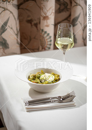 Pasta with pesto sauce and white wine 136941909