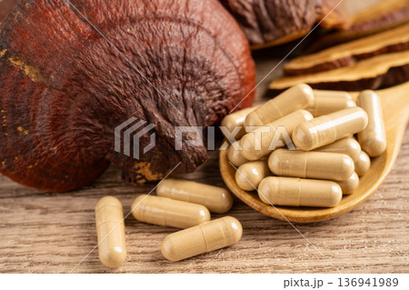 Lingzhi or Reishi mushroom with capsules, organic natural healthy food. Lingzhi or Reishi mushroom with capsules, organic natural healthy food. 136941989