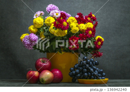 Still life with a bouquet of chrysanthemums, grapes, and apples 136942240