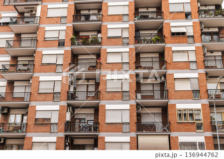Residential apartment building facade with balconies and windows in Rome, Italy 136944762