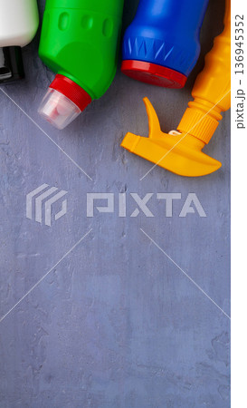 Bottles of cleaning products on a gray surface during daylight hours in a home setting Bottles of cleaning products on a gray surface during daylight hours in a home setting 136945352