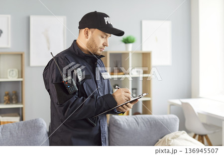 Detective Or Police Officer Filling Out Report At Crime Scene Investigation Detective Or Police Officer Filling Out Report At Crime Scene Investigation 136945507
