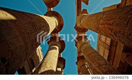 Ancient columns of Karnak Temple in Luxor Egypt viewed from below at sunset Ancient columns of Karnak Temple in Luxor Egypt viewed from below at sunset 136946076