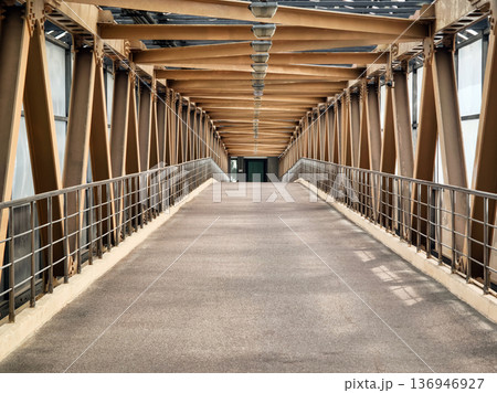 Walking path on a metal bridge in an urban area during the daytime Walking path on a metal bridge in an urban area during the daytime 136946927