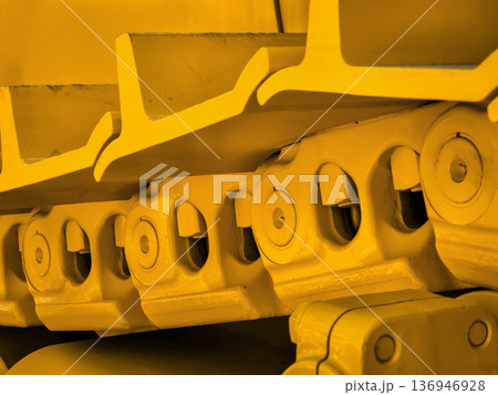 A close view of yellow tracks for heavy machinery rests A close view of yellow tracks for heavy machinery rests 136946928