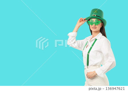 A young woman wears a green hat and glasses for St. Patrick's Day A young woman wears a green hat and glasses for St. Patrick's Day 136947621