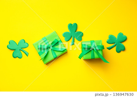 Bright yellow background featuring green gifts and shamrocks 136947630