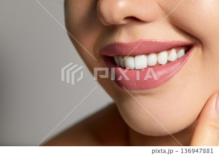Beauty Face. Beautiful Woman With Natural Makeup And Sexy Full Lips Touching Her Mouth. Closeup Portrait Of Smiling Model Girl With Healthy Smooth Facial Skin Applying Lip Balm On Lip. High 136947881