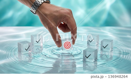 Businessman Hand Picking Red Target Cube for Strategic Goal Setting 136948264