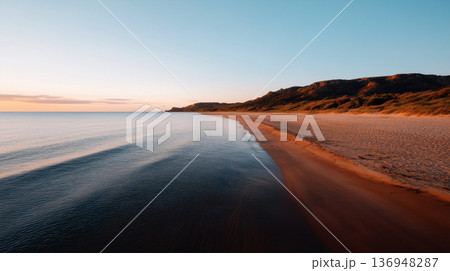 A rugged ocean coastline with large, jagged rocks protruding from the water, waves crashing against them	 136948287