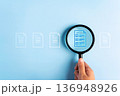 Close up to hand, hold magnifier to search file to management about document is important business. 136948926