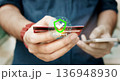 Online security payment concept. Man use smart phone and holding credit card with shopping online. 136948930