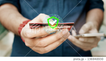 Online security payment concept. Man use smart phone and holding credit card with shopping online. 136948930