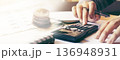 Man using calculator and calculating budgeting and tax calculation monthly expenses. 136948931