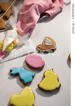 Decorating Festive Easter Gingerbread Cookies With Colorful Icing for Celebration Decorating Festive Easter Gingerbread Cookies With Colorful Icing for Celebration 136949390