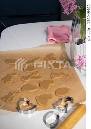 Making Easter Cookies With Bunny Shapes and Other Designs in a Kitchen Setting 136949400