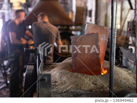 Foundry - ferrous metal is melted in an induction furnace of metallurgical plant Foundry - ferrous metal is melted in an induction furnace of metallurgical plant 136949462