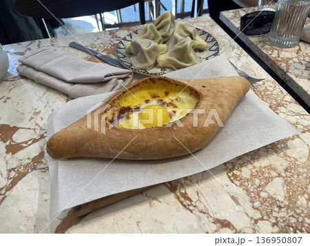 plate of khachapuri on the table in restaurant, traditional georgian food plate of khachapuri on the table in restaurant, traditional georgian food 136950807