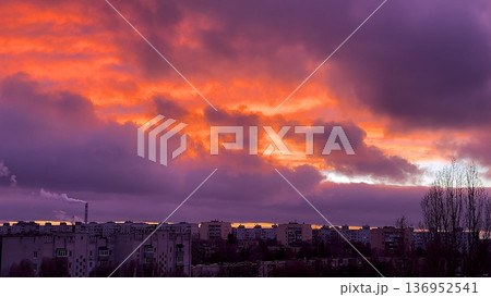 Red cloudy sky over a big city at sunset.  136952541