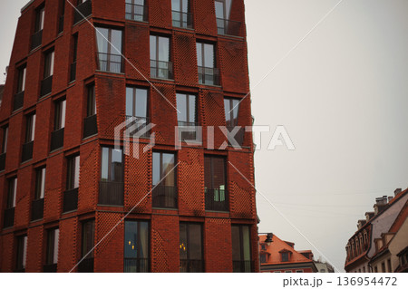 Modern Red Brick Residential Building with Balconies in European City Modern Red Brick Residential Building with Balconies in European City 136954472
