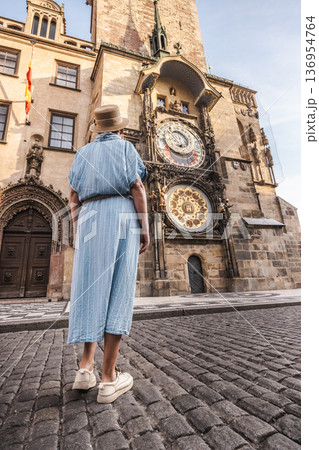 Woman tourist looking at Prague Astronomical Clock on Old Town Hall in Prague, Czech Republic historic landmark Woman tourist looking at Prague Astronomical Clock on Old Town Hall in Prague, Czech Republic historic landmark 136954764