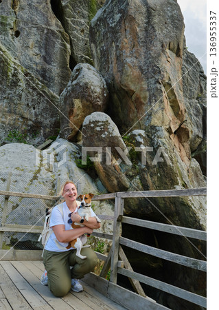 Woman Hiking with Dog on Mountain Trail Woman Hiking with Dog on Mountain Trail 136955337