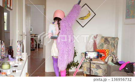 Energetic individual showcasing dance in vividly decorated setting Energetic individual showcasing dance in vividly decorated setting 136956732