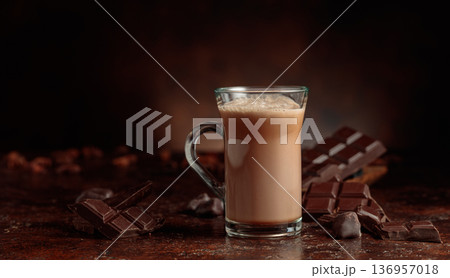 Cocoa drink in glass mug and pieces of  bitter chocolate. 136957018