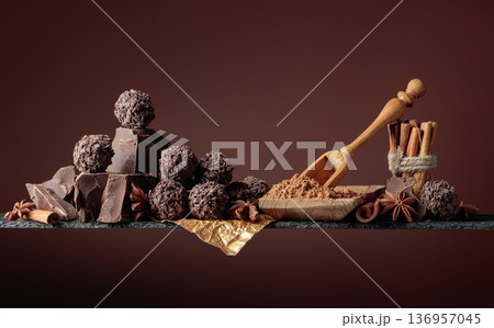 Chocolate truffles with broken pieces of chocolate and spices. 136957045