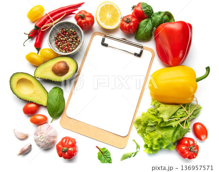 Fresh vegetables and clipboard for healthy meal planning Fresh vegetables and clipboard for healthy meal planning 136957571
