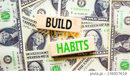 Build habits symbol. Concept word Build habits on beautiful wooden blocks. Dollar bills. Beautiful dollar bills background. Business build habits concept. Copy space. Build habits symbol. Concept word Build habits on beautiful wooden blocks. Dollar bills. Beautiful dollar bills background. Business build habits concept. Copy space. 136957619