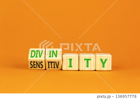 Sensitivity or divinity symbol. Concept words Sensitivity or Divinity on wooden cubes. Beautiful orange background. Psychology sensitivity or divinity concept. Copy space. 136957778