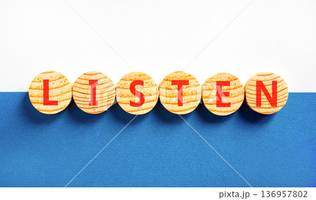 Listen symbol. Concept word Listen on beautiful wooden circles. Beautiful blue and white background. Business education listen concept. Copy space. 136957802