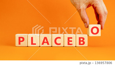 Placebo word medical symbol. Concept word Placebo on beautiful wooden blocks. Beautiful orange background. Doctor's hand. Business placebo word medical concept. Copy space. 136957806