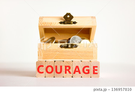 Courage symbol. Concept word Courage on beautiful wooden blocks. Beautiful white background. Beautiful wooden chest with coins. Business courage concept. Copy space. 136957810
