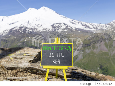 Consistency is the key symbol. Concept words Consistency is the key on beautiful blackboard. Beautiful mountain Elbrus background. Business consistency is the key concept. Copy space. 136958032