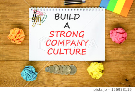 Strong company culture symbol. Concept words Build a strong company culture on beautiful white note. Beautiful wooden background. Colored paper. Business strong company culture concept. Copy space. Strong company culture symbol. Concept words Build a strong company culture on beautiful white note. Beautiful wooden background. Colored paper. Business strong company culture concept. Copy space. 136958119