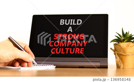 Strong company culture symbol. Concept words Build a strong company culture on beautiful black tablet's screen. Beautiful white background. Business strong company culture concept. Copy space. 136958148
