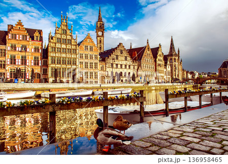 Ghent city historical center, tourists boats and colorful buildings on Leie river bank, Belgium 136958465