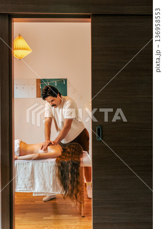 Male Therapist Giving Relaxing Back Massage to Woman Male Therapist Giving Relaxing Back Massage to Woman 136958553