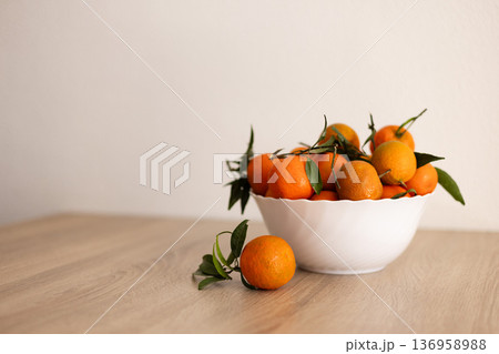 Full bowl of fresh tangerine on a wooden table. Full bowl of fresh tangerine on a wooden table. 136958988