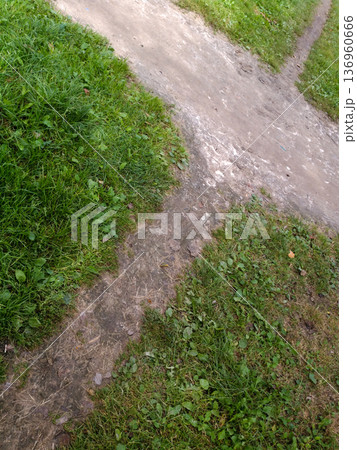 Earthen crossroads on the grass. 136960666